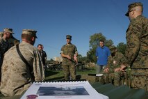 Captain David C. Joseforsky, SWAN Project Officer at Marine Corps Systems Command, speaks to 26th MEU Marines before they use the MSWAN satellite communications system, Oct. 2, 2006, at Fort Pickett, Va.  The MSWAN system will allow the MEU to deploy its elements to a distance of 10,000 miles apart and still maintain data and voice connectivity.