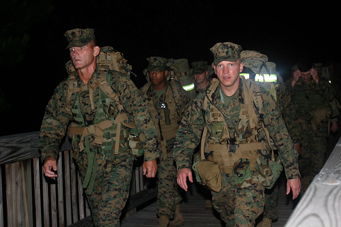 MARINE CORPS BASE CAMP LEJEUNE, N. C. - (June 2, 2006)-- Lt. Col Kenneth P. Wolf, commanding officer of Company "A", Foreign Military Training Unit, Marine Corps Forces Special Operations Command, and Company First Sergeant  Jack J. Pettis lead their troops on a 12-mile hike. The hike, which started here at 2 a.m., featured additional media interview skills and practical application training. (Official U.S. Marine Corps Photo by Cpl. Ken Melton)