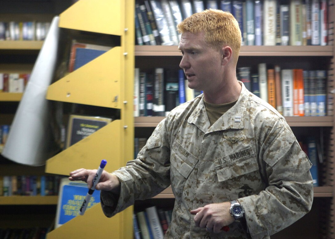 Captain Paul Blair, air officer for Battalion Landing Team 1st Bn., 2nd Marines, helps strengthen platoons by teaching them how to conduct casualty evacuations and landing zone briefs in the library aboard the USS Nassau, Dec. 2, 2005.  The BLT is the ground combat element of the 22nd Marine Expeditionary Unit (Special Operations Capable), which is currently deployed as the landing force for Expeditionary Strike Group 8.