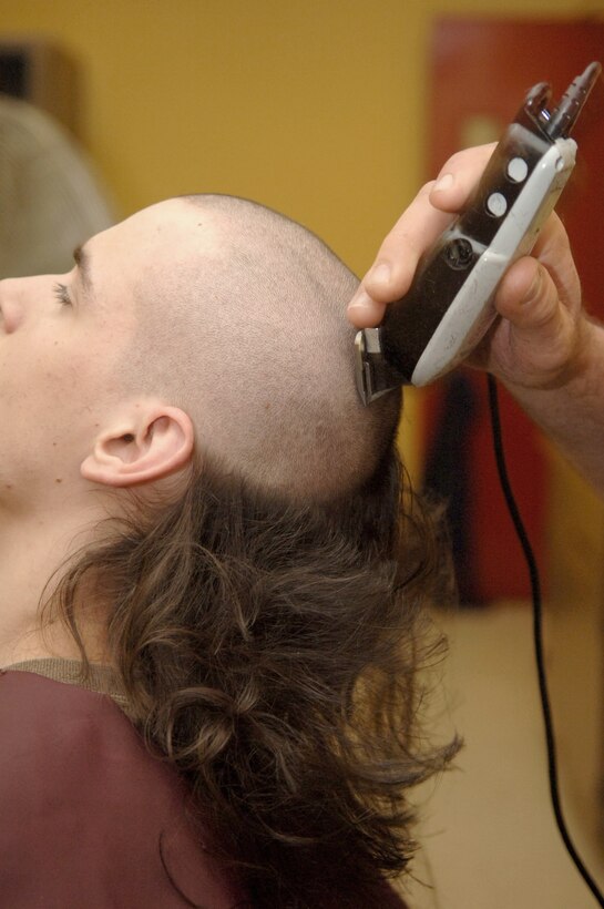 Pvt. Josiah Gulke from Marysville, Wash., was one of the first new recruits from Platoon 2070 to get his head shaved by barber Frank Sardina here. Recruits get their heads shaved in training to ensure cleanliness.