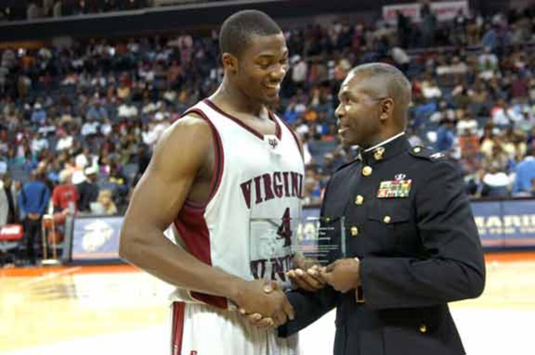 Colonel Ronald Bailey, commanding officer, Expeditionary Warfare School, Quantico, Va., awards Panthers forward, Brad Byerson, Virginia Union University, with a Marine Corps ?Excellence in Leadership? award for being the team?s most valuable player