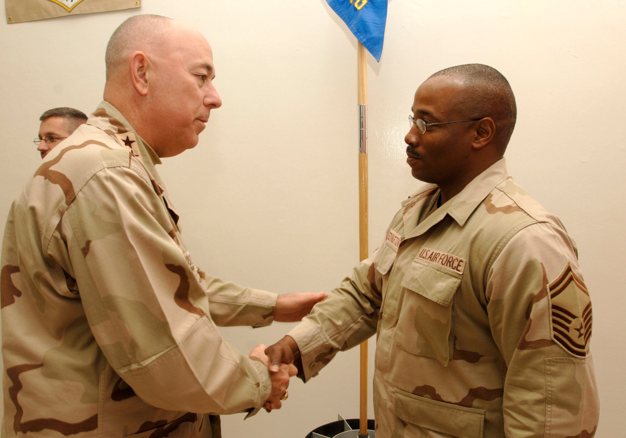 BALAD AIR BASE, Iraq (AFPN) -- Chief of Staff of the Air Force Gen. T. Michael Moseley shakes hands with Senior Master Sgt. David Wedington during a visit here. Sergeant Wedington is with the 732nd Expeditionary Logistics Readiness Squadron. (U.S. Air Force photo by Airman 1st Class Chad Watkins)