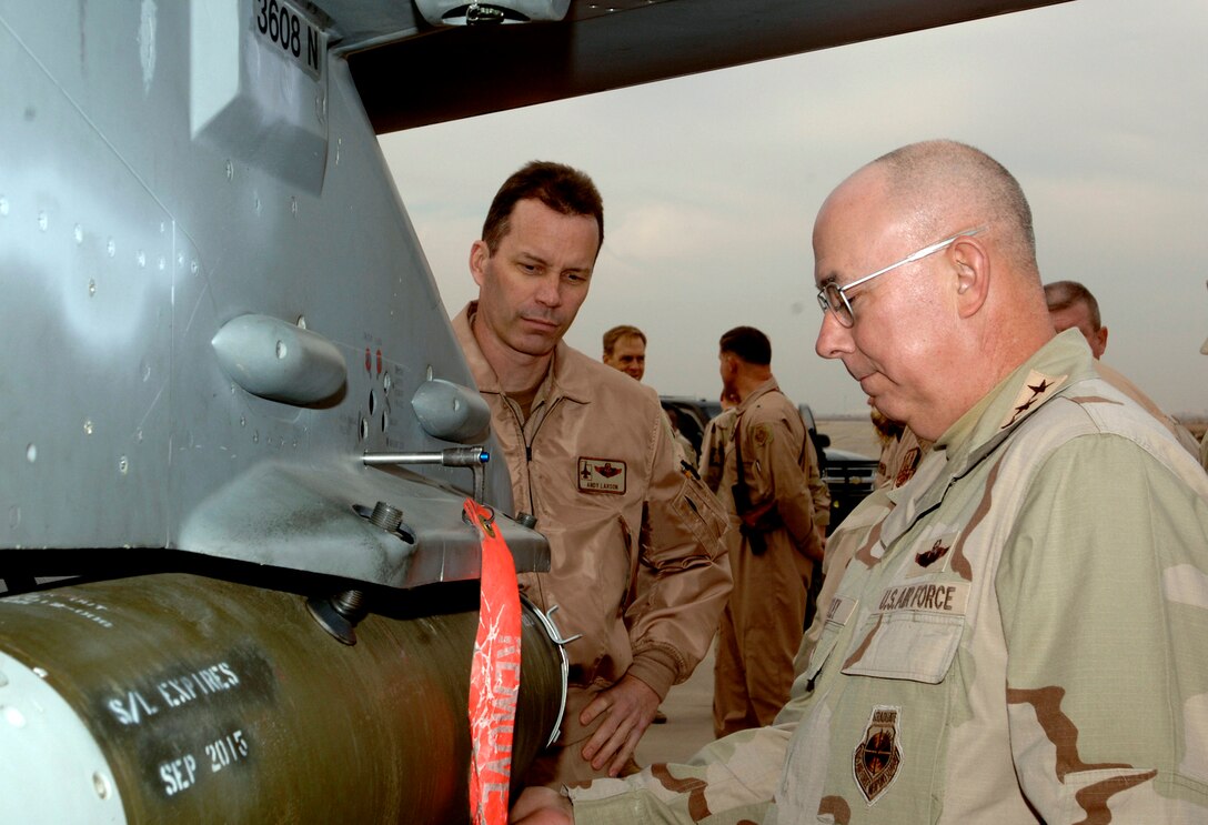 BALAD AIR BASE, Iraq (AFPN) -- Air Force Chief of Staff Gen. T. Michael Moseley examines a joint direct attack munition loaded on an F-16 Fighting Falcon with Lt. Col. Andrew Larson. Colonel Larson is with the 332nd Expeditionary Fighter Squadron. (U.S. Air Force photo by Airman 1st Class Chad Watkins)