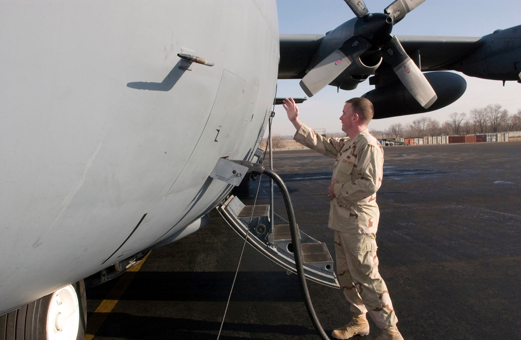 MANAS AIR BASE, Kyrgyzstan (AFPN) -- Chaplain (Maj.) Mark Rowan blesses the last C-130 Hercules assigned here before its final departure to its new home at Bagram Air Base, Afghanistan. The aircraft is part of the North Carolina Air National Guard's 774th Airlift Squadron. (U.S. Air Force photo by Jim Westfall)