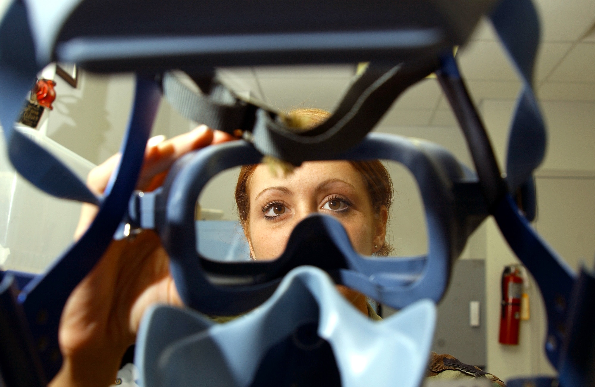 MACDILL AIR FORCE BASE, Fla. (AFPN) -- Senior Airman Corinna Carver inspects a quick-don mask. Aircrew’s use the masks if smoke enters an aircraft’s cockpit. Airman Carver is an aircrew life-support technician with the 91st Air Refueling Squadron. (U.S. Air Force photo by Airman 1st Class Bradley A. Lail)