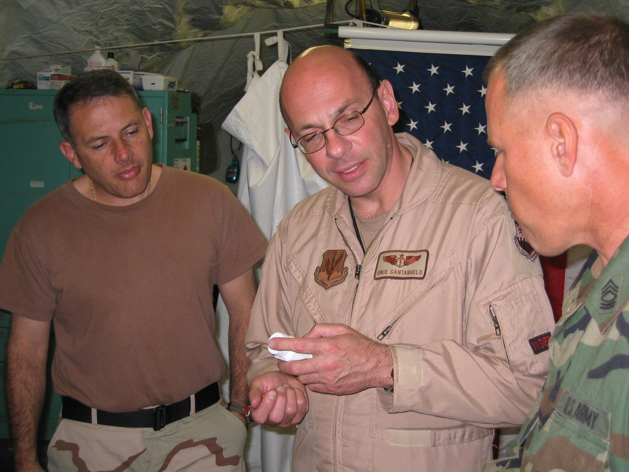ISLAMABAD, PAKISTAN (AMCNS) – Master Sgt. Luis Valladares (left), independent duty medical technician, and Lt. Col. (Dr.) Vince Santangelo (center), air transportable clinic commander, discuss medication options with a soldier assigned to the humanitarian relief operation in Pakistan. (Photo by 1st Lt. Erick Saks)