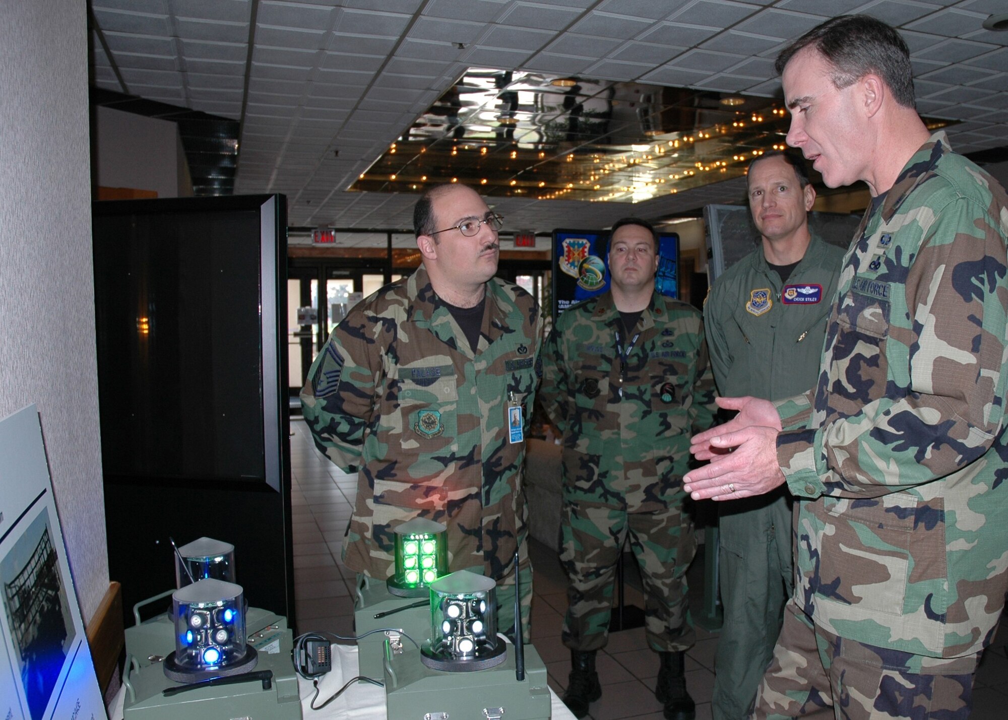 MCGUIRE AIR FORCE BASE, N.J. (AMCNS) -- During the open house hosted by the Air Mobility Battlelab here, Senior Master Sgt. Michael Palase, left, project manager for the Advanced Contingency Airfield Lighting System, discusses the device with the lab’s Combat Support Division Chief Maj. Steve Molos; Air Mobility Warfare Center Vice Commander Col. Charles Stiles; and Brig. Gen. Robert H. McMahon, director of logistics for Air Mobility Command. (Photo by Staff Sgt. Tanaya Harms, Air Mobility Warfare Center)