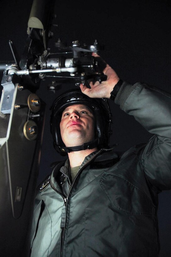 Maj. James Isaacs, Marine Aviation Weapons and Tactics Squadron 1 HH-1N Huey Search and Rescue helicopter co-pilot and a native of Clarion, Pa., conducts a preflight inspection in front of the SAR hangar Jan. 5. Frequent inspections and training keep SAR crewmen ready to respond to emergencies at any time.