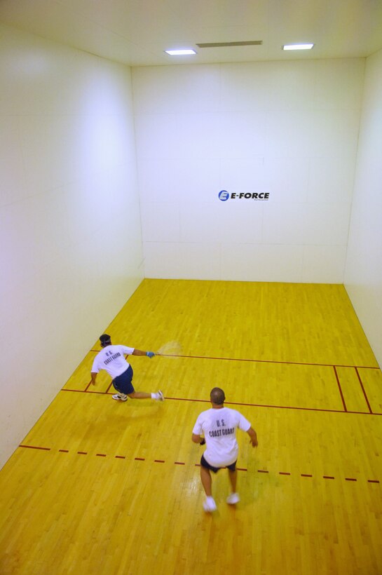 Chief Warrant Officer Freddy Alvizo chases down a loose ball after Petty Officer 2nd Class Samuel Wilson returned it. Alvizo defeated Wilson in the championship game at this year?s CG?s Cup racquetball tournament.