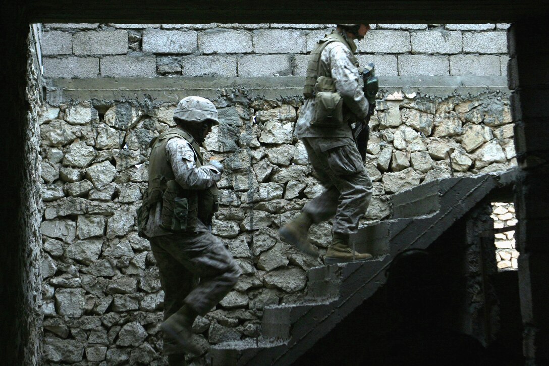 U.S. Marine Corps Pvt. Jeff L. Hale and Lance Cpl. Dana J. Mattice clear an abandoned house during a weapons search in Al Ish, Iraq, May 6, 2006. The Marines are from Weapons Company, 1st Battalion, 7th Marine Regiment, I Marine Expeditionary Force (Forward). (U.S. Marine Corps photo by Cpl. Brian M. Henner) (Released)