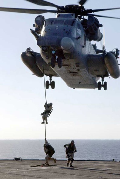 030117-N-0000K-001At sea aboard USS Mount Whitney (LCC/JCC 20) Jan. 17, 2003 -- A U.S. Navy SEAL (SEa, Air, and Land) fast-ropes from an MH-53 RPave LowS helicopter during a Maritime Interception Operation (MIO) training exercise.  U.S. Navy SEALs are deployed throughout the world conducting missions in support of Operation Enduring Freedom.  U.S. Navy photo by Petty Officer 2nd Class George R. Kusner.  (RELEASED)                           