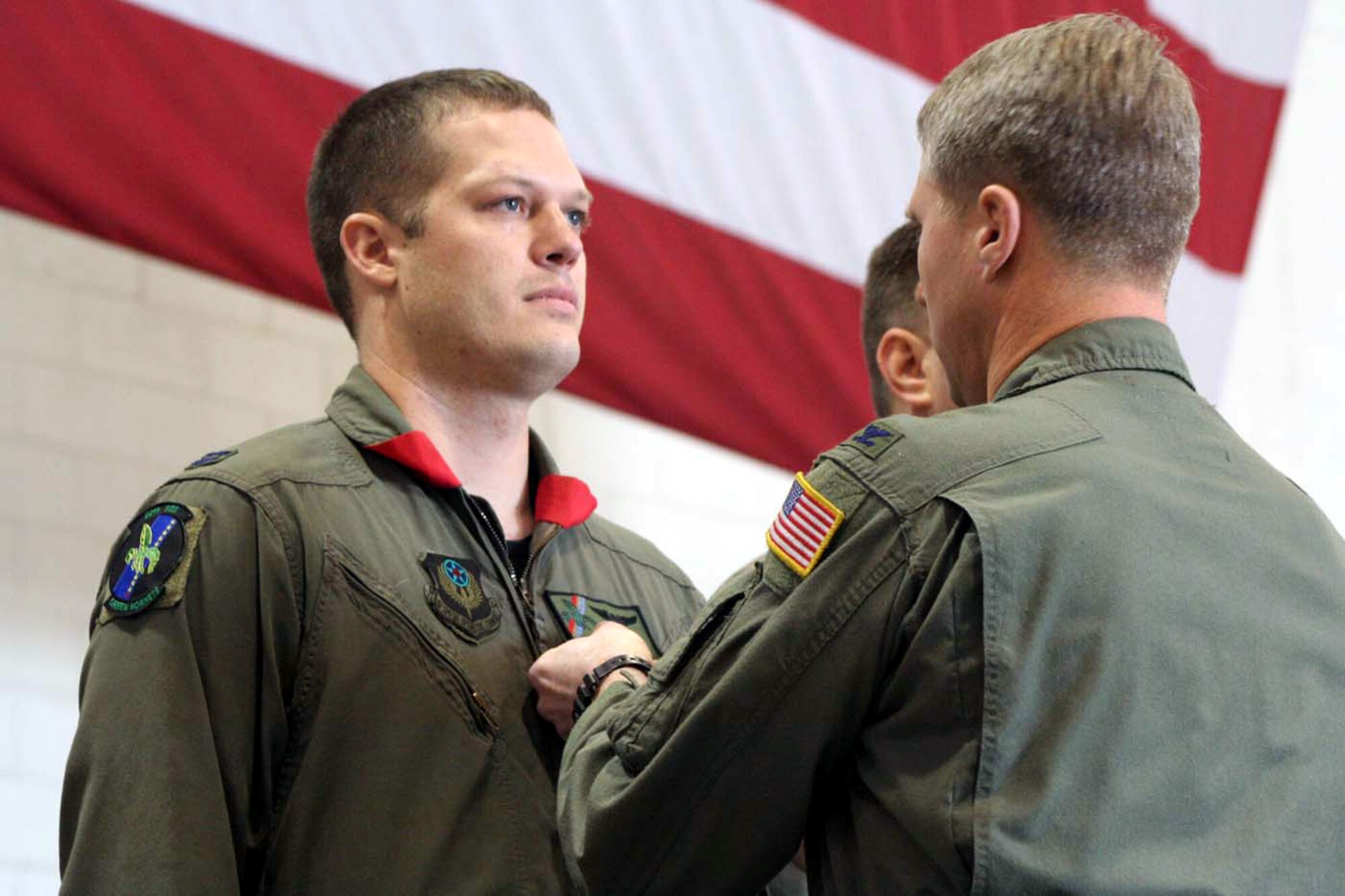 Capt. Matthew Berry, 20th Special Operations Squadron, receives his Distinguished Cross with Valor from Col. Mark Alsid, 20th SOS commander, during a ceremony Dec. 16 in Freedom Hangar. (U.S. Air Force photo by Senior Airman Heidi Davis)
