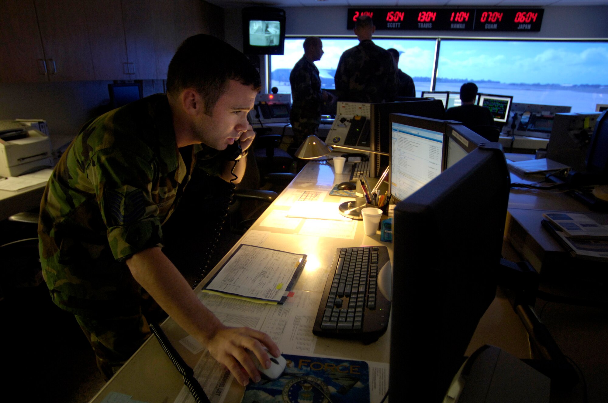 HICKAM AIR FORCE BASE, Hawaii (AFPN) -- Staff Sgt. Joseph Brady alerts aircrews for their flight from the Air Mobility Command Center here. It is the nerve center for coordinating all uploads of cargo and passengers. It also accommodates and alerts aircrews. Sergeant Brady is with the 735th Air Mobility Squadron. (U.S. Air Force photo by Tech. Sgt. Shane A Cuomo)