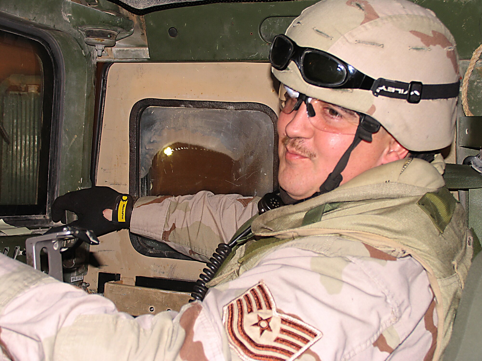 CAMP BUCCA, Iraq (AFPN) -- Tech. Sgt. Michael Taylor talks with his driver during a routine patrol. Sergeant Taylor is a flight sergeant with the 586th Expeditionary Security Forces Squadron and in charge of the mobile patrols inside the camp. He is from West Terre Haute, Ind., and deployed from Ellsworth Air Force Base, S.D. (U.S. Air Force photo)