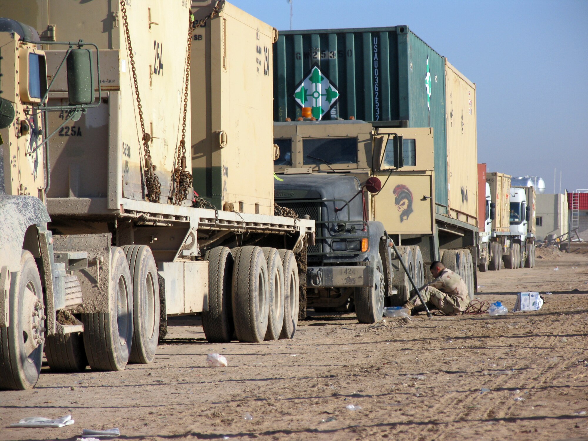 SOUTHWEST ASIA (AFPN) -- Vehicle operator Senior Airman David Marchuk puts air in his tractor-trailer's tire before rolling out on a convoy to Iraq.  (U.S. Air Force photo by Staff Sgt. Scott Campbell)