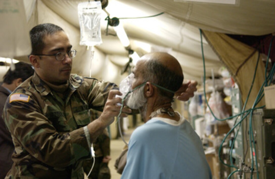 Army 1st Lt. Ruben Vazquez treats a patient at the 212th Mobile Army Surgical Hospital in Muzaffarabad, Pakistan, on Jan. 5, 2006. The Department of Defense is supporting the State Department by providing disaster relief supplies and services following the massive earthquake that struck Pakistan and parts of India and Afghanistan. 