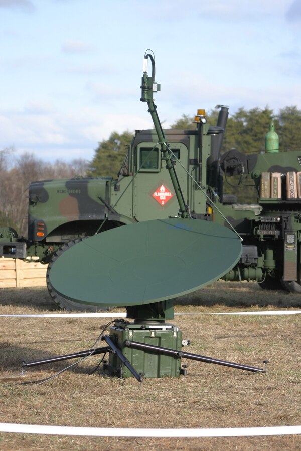 The Logistics Support Wide Area Network dish sits outside the Marine Expeditionary Unit Service Support Group 24 communication tent Jan 6, 2006 at Ft. A.P. Hill. The LSWAN gives Marines the capability to establish a wireless network in theater and set up Non-secure Internet Protocol Router (NIPR), Secure Internet Protocol Router (SIPR), and it works in conjunction with other logistics systems.   (U.S. Marine Corps Photo by Cpl. Matt Lyman)