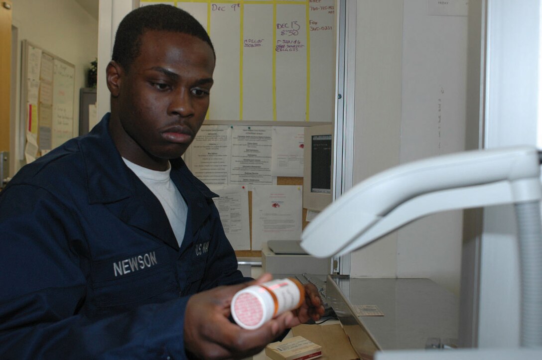 Seaman Apprentice Willie Newson, Branch Medical Clinic pharmacy technician, scans a prescription before dispensing it Jan. 6 in the BMC pharmacy. All of the prescriptions are logged into the computer system to help reduce the chance for error involving all medications, from blood pressure medications to cough syrup.