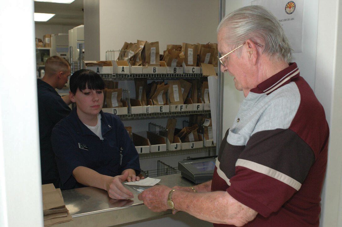 Seaman Jackie Kaltz, Branch Medical Clinic pharmacy technician, receives prescription information from a military retiree at the BMC pharmacy Jan. 6. In addition to active military members and their family members, the pharmacy also fills prescriptions for military retirees, who can be numerous during the winter months.