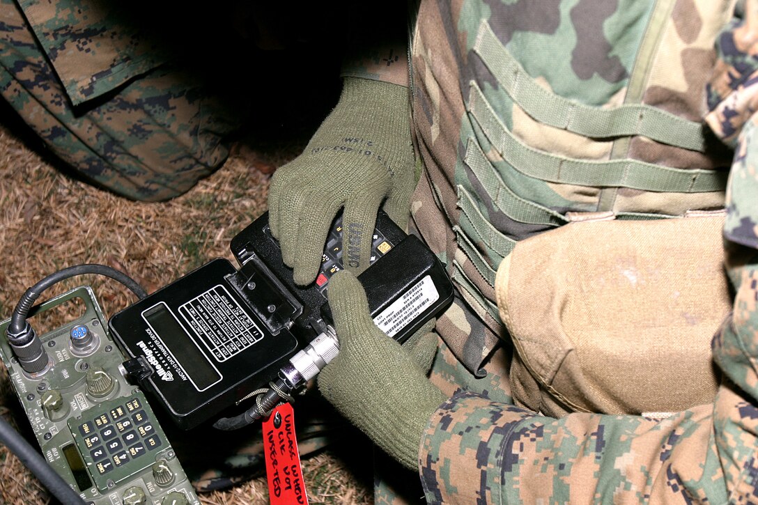 Lance Cpl. Adrian M. Negron, 26th MEU field radio operator, uses a CYZ-10 encryption device to encrypt a frequency sequence during a communications field exercise aboard Marine Corps Auxillary Landing Field, Bogue, N.C.