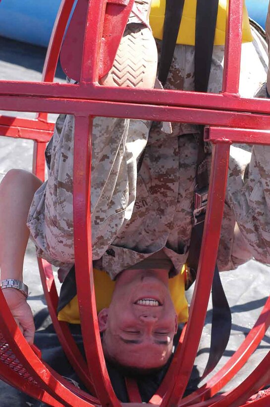 Sgt. Dustin Lawson, an air conditioner technician with Marine Aviation Logistics Squadron 13, just hangs around for his friends to let him out of the bowling ball cage at the Single Marine and Drug Demand Reduction programs? spring break barbeque April 7 at softball field 545 across from the gymnasium here. Unfortunately, Lawson did not bowl a strike so he had to go for the spare.