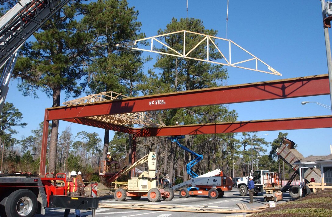 Carpenters and framers with Pro Construction Inc., secured trestles during construction of the new canopy over the main gate at Camp Lejeune Jan. 7.