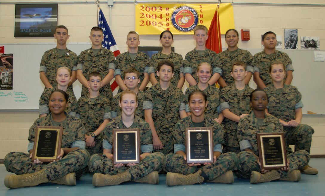 MARINE CORPS BASE CAMP LEJEUNE, N.C. ? Cadet Gunnery Sgt. Kiara Harris, 16, Cadet 2nd Lieutenant Melanie R. Guy, 16, Cadet 2nd Lieutenant Destiny Ma?ave-Kuewa, 16, Cadet Gunnery Sgt. Wynetta Hughley, 16, sit in from of the rest of their Camp Lejeune high School Junior Reserve Officer Training Corps class holding plaques representing the 2003 ? 2006 awards for the Naval Honor School Award. It is the forth year in a row that the CLHS has won this prestigious honor.