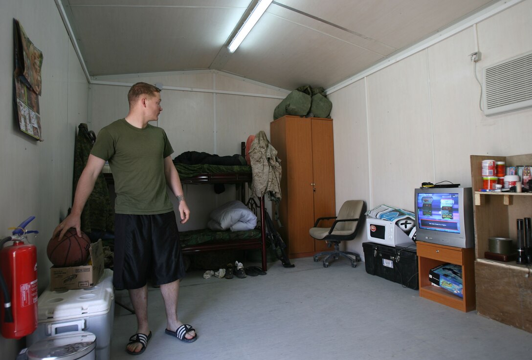 Cpl. Patrick Kennedy, 3rd Battalion, 5th Marine Regiment, stands inside his new living quarters on Camp Fallujah, April 9.  Like many Marines in the battalion, the 21-year-old from Portage, Ind., now shares a room with three other Marines, compared to living in a room with 18 others back on Camp Mercury.