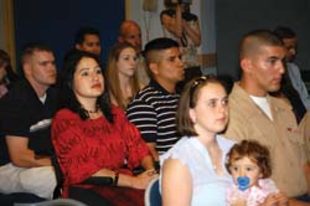Cpl. Howard Martin (right), Headquarters and Headquarters Squadron ground support equipment mechanic and native of King, N.C., and Lance Cpl. James Christian (far left), H&HS weather observer and native of Wichita, Kan., prepare to receive the Citizen Life Saving Award, presented by the Arizona Department of Public Safety director, May 8 at the Arizona Department of Transportation Human Resources Development Center in Phoenix, Ariz. The Marines received the award for saving the life of Yvonne Llanes (red-shirt), wife to a Marine Corps recruiter, in an incident that occurred on Sept. 18 in front of Kirkland?s Home store at Yuma Palms Regional center