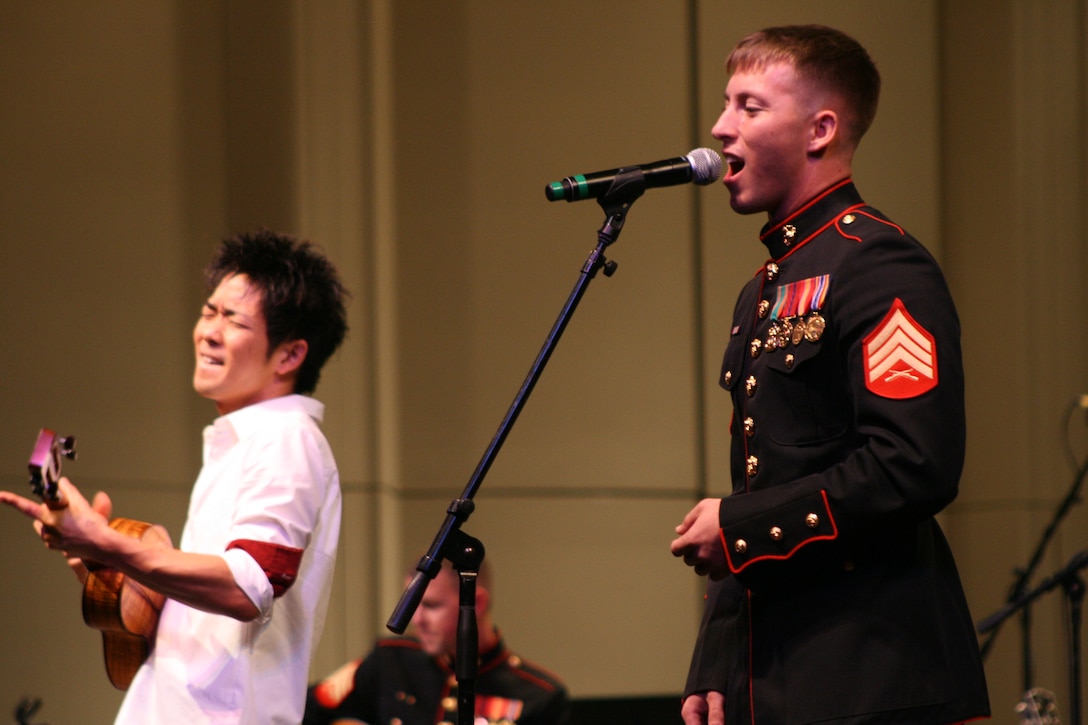 Sgt. Zachary Wendt, trombone player with the U.S. Marine Corps Forces, Pacific Band, sings 'Hallelujah' with Jake Shimabukuro playing ukulele during the Na Mele o na Keiki, 'Music for the Children' Toys for Tots concert at the Neal S. Blaisdell Concert Hall Dec 10.