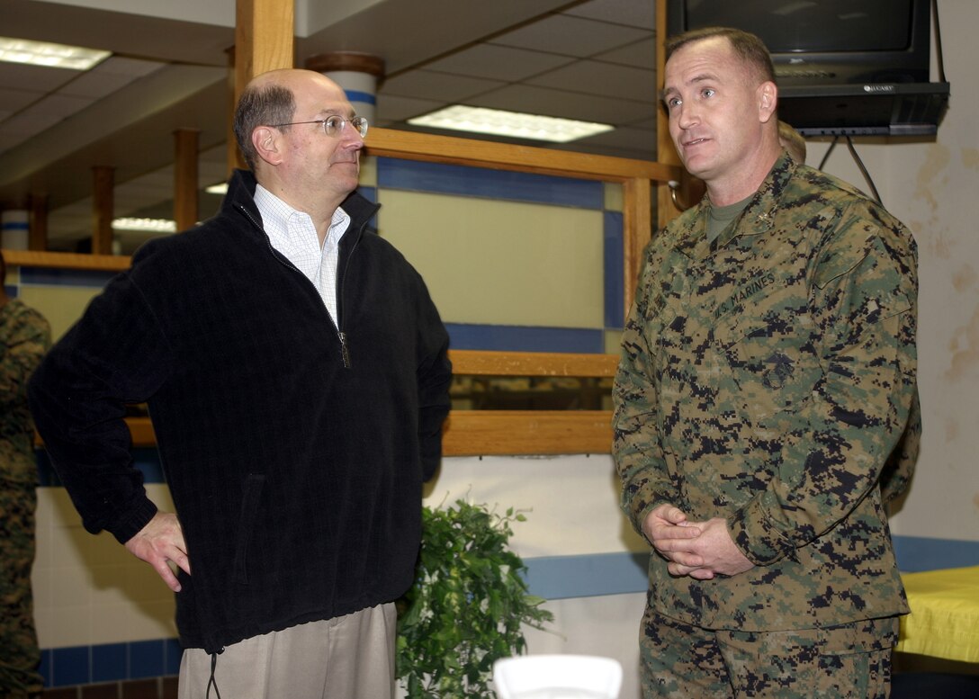 MARINE CORPS BASE CAMP LEJEUNE, N.C. - Secretary of the Navy Donald C. Winter listens as Lt. Col. William Jurney, 1st Battalion, 6th Marine Regiment's commander, introduces his Marines before the Secretary's breakfast with them here Jan. 9.  During his daylong tour of the base, Winter spoke with several personnel from the 2nd Marine Division to get a firsthand account of how troops were training in garrison and conducting combat operations in the Global War on Terrorism overseas.  Winter was sworn into office Jan. 3 and serves as the 74th Secretary of the Navy, overseeing approximately 900,000 personnel and an annual budget of $125 billion.