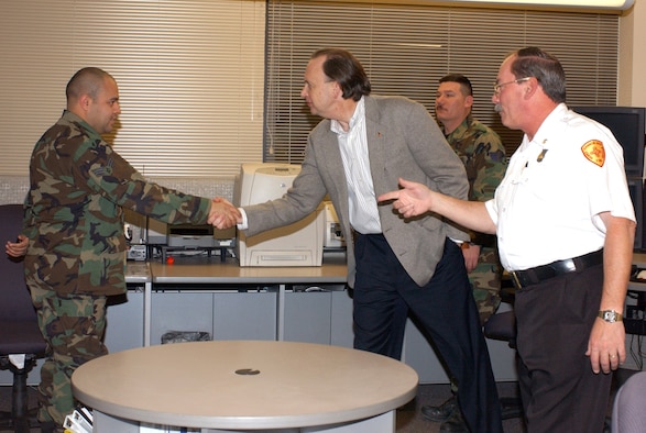 CANNON AIR FORCE BASE, N.M. (AFPN) -- Senior Airman Alberto Flores and Richard Givney, brief Assistant Secretary of the Air Force William C. "Bill" Anderson on the recently constructed Fire Department during his visit here. Mr. Givney pointed out new features such as the Control Center, vehicle bays, and the training room. Airman Flores and Mr. Givney are from the 27th Civil Engineer Squadron. (U.S. Air Force photo by Airman 1st Class Heather Salazar)