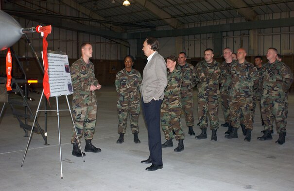 CANNON AIR FORCE BASE, N.M. (AFPN) -- Senior Airman Ross Steen briefs Assistant Secretary of the Air Force William C. "Bill" Anderson on the Common Configuration Implementation Program during his visit here. The CCIP is an upgrade for the Block 50 model of the F-16 fighter aircraft through avionics and software updates that involve new color displays and an Air-to-Air Interrogator, which will allow communication with other aircraft that appear on radar. Airmen Teen is with the 27th Aircraft Maintenance Squadron. (U.S. Air Force photo by Airman 1st Class Heather R. Salazar)