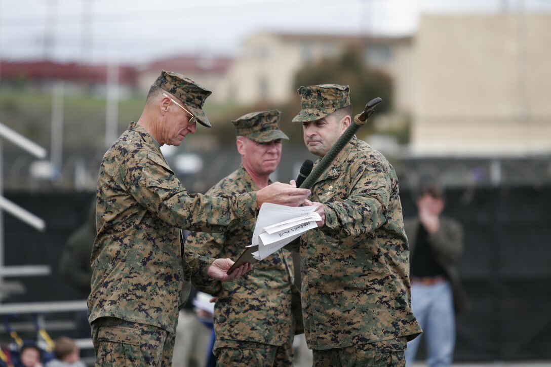 060310-M-3677-001 MARINE CORPS BASE CAMP PENDLETON, Calif. -- Col. Robert J. Coates passes on the reconnaissance paddle to Lt. Gen. John F. Goodman at the deactivation ceremony of Marine Corps Special Operations Capable Detachment One. The three-year-old experimental unit was similair to the Marine Raiders of World War II, some of whom were present at the deactivation ceremony March 10. Coates is the commanding officer of Detachment One and Goodman is the Commanding General of Fleet Marine Force Pacific. (Official U.S. Marine Corps photo by Lance Cpl. Sara Cantrell)(released)