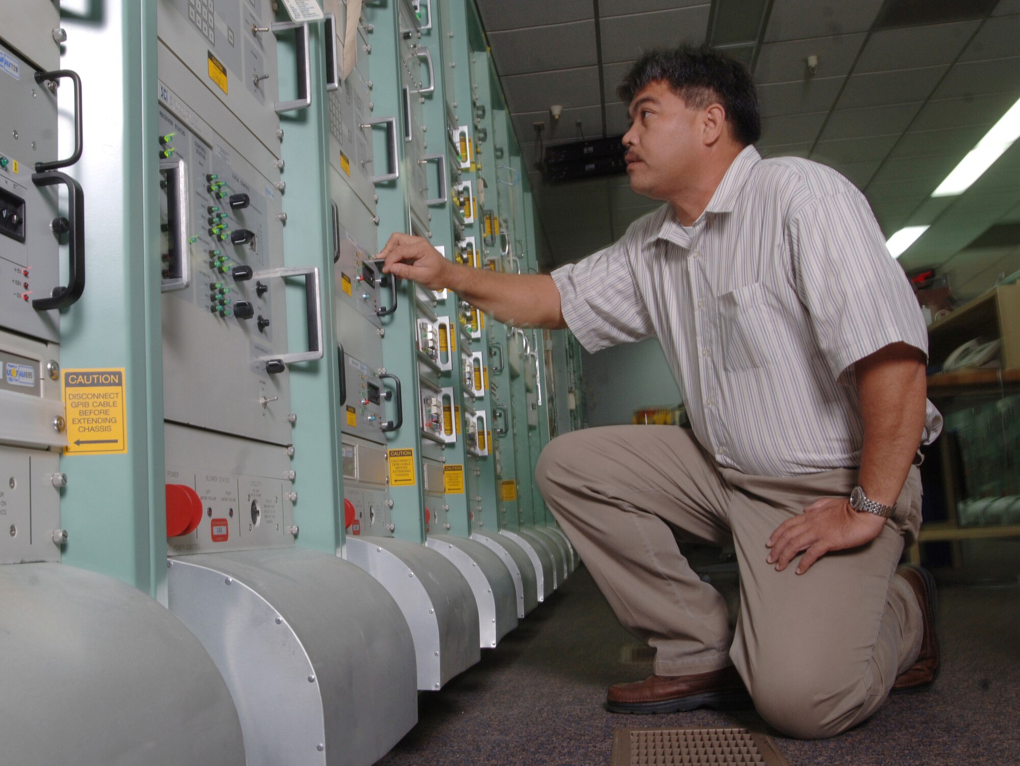 ANDERSEN AIR FORCE BASE, Guam (AFPN) -- Juan Arriola troubleshoots a switch matrix equipment during an inspection at his facility. Mr. Arriola is an automated remote tracking controller with the Detachment 5, 22nd Space Operations Squadron here. Their mission is to execute on demand, real-time, command and control operations for launch and operations of 170 Department of Defense, national, allied and civilian satellites. (U.S. Air Force photo by Master Sgt. Val Gempis)