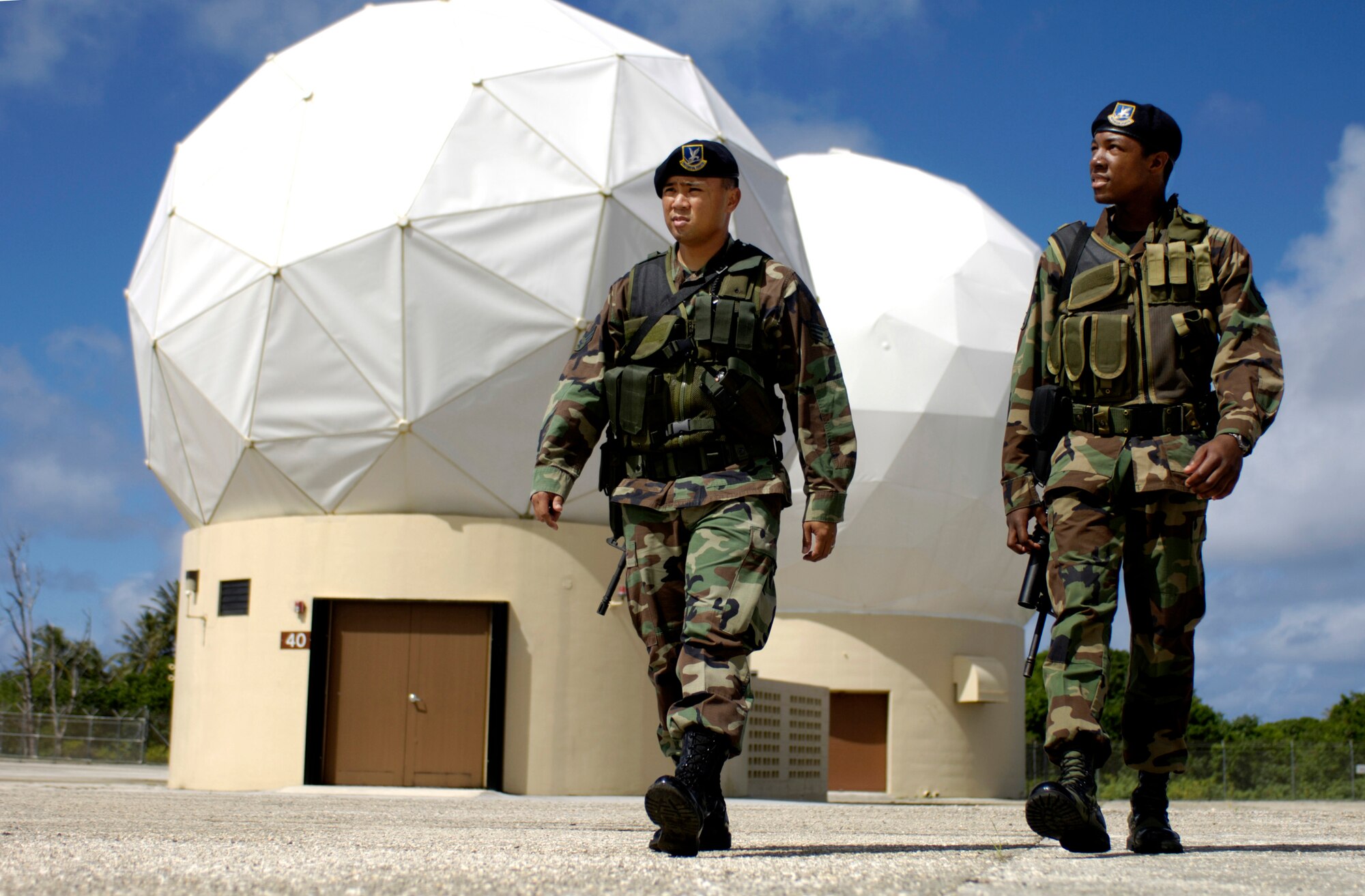 ANDERSEN AIR FORCE BASE, Guam (AFPN) -- Senior Airman Alvin Alvarez and Airman 1st Class Robert Young check the perimeter at Detachment 5, 22nd Space Operations Squadron's satellite tracking station. The Airmen are with the 36th Security Forces Squadron, which provides security for the station 24 hours a day. (U.S. Air Force photo by Tech. Sgt. Shane A. Cuomo)