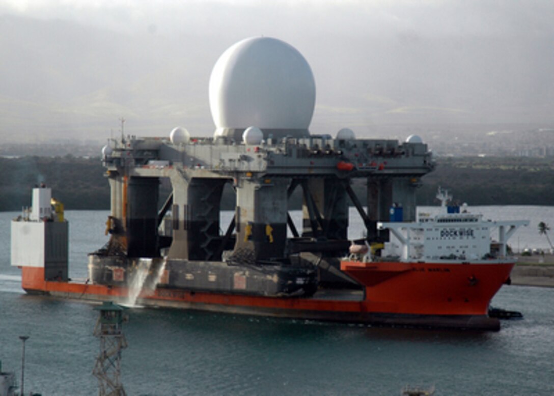 The heavy lift vessel MV Blue Marlin with its deck cargo of the Sea Based X-Band Radar enters Pearl Harbor, Hawaii, after completing a 15,000-mile journey from Corpus Christi, Texas, on Jan. 9, 2006. The Sea Based X-Band Radar is a combination of the world's largest phased array X-band radar carried aboard a mobile, ocean-going semi-submersible oil platform. The radar is capable of highly advanced, ballistic missile detection while discriminating a hostile warhead from decoys and countermeasures. The platform, larger than a football field, will undergo minor modifications, maintenance and routine inspections in Pearl Harbor before completing its voyage to its homeport of Adak, Alaska, in the Aleutian Islands. 