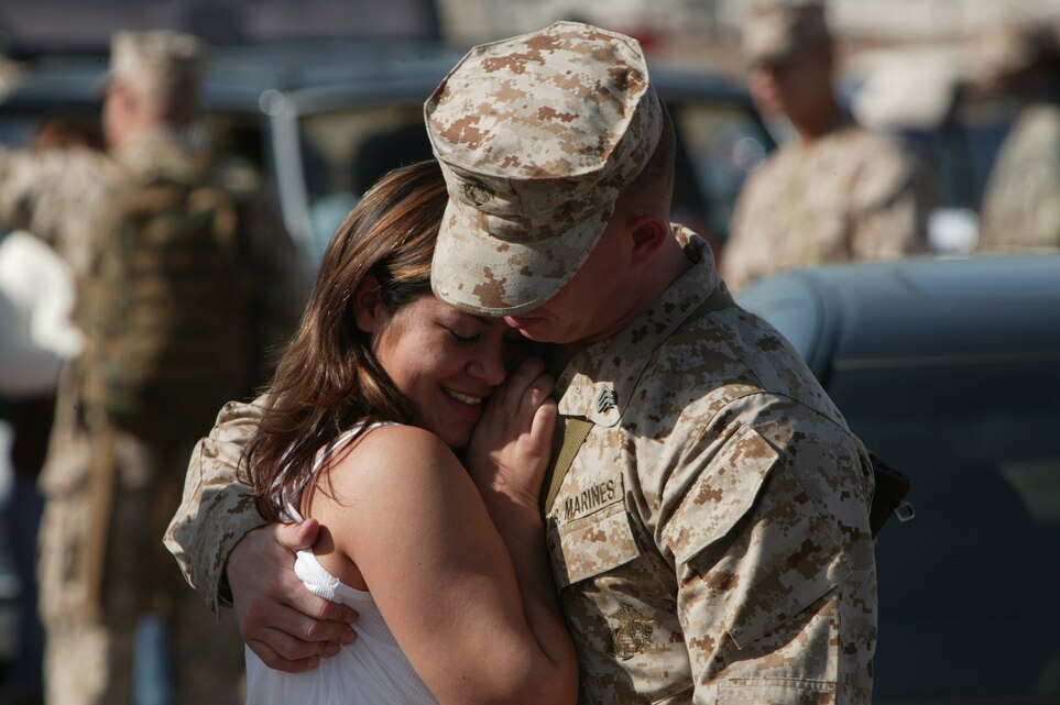 Sgt. Joshua Lintz embraces his wife Sondra as he prepares to board the bus for the first leg of a long journey to Iraq. Lintz is an aviation ordinance technician with Marine Aviation Logistics Squadron 16 and this makes his second deployment to Iraq in less than two years.