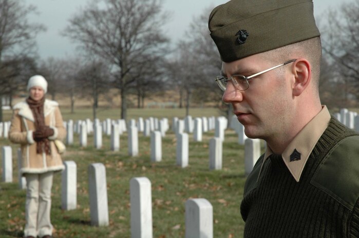 ARLINGTON, Va.--Sergeant Robert A. Kelm reflects upon the life of his grandfather as his wife observes from a distance at Arlington National Cemetery Feb. 10.  Kelm, a member of the Chemical Biological Incident Response Force reenlisted at Army 1st Lt. Arthur W. Kelm's final resting place to pay tribute to his service in WW II.