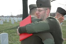ARLINGTON, Va. - Sgt. Robert A. Kelm, of the Chemical Biological Incident Response Force (CBIRF), embraces one of his fellow Rescue platoon Marines after reenlisting at his grandfather's final resting place in Arlington National Cemetery Feb. 10.  According to Kelm, the bond he developed with his fellow Marines at CBIRF played a key role in his decision to reenlist.  "I consider the Marines in Rescue Platoon my brothers and sisters," said Kelm.  "I would give my life for any of them."