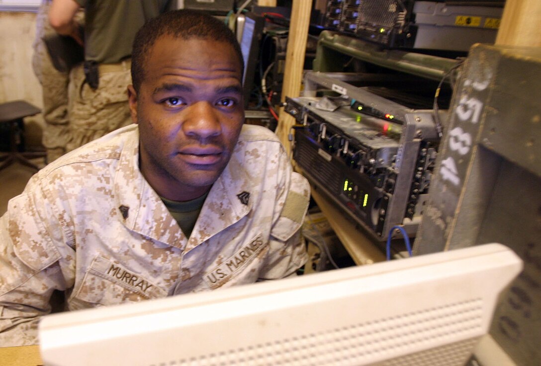 CAMP AL QA'IM, Iraq (Dec. 10, 2005) -- Chicago native Sgt. Leonard C. Murray, data section chief, communications platoon, Headquarters & Support Co., 3rd Battalion, 6th Marine Regiment, Regimental Combat Team - 2 sits at his usual post -- behind the computer screen.  Murray is in charge of the various networks Marines use aboard Camp Al Qa'im.  (Official U.S. Marine Corps photo by Sgt. Jerad W. Alexander)