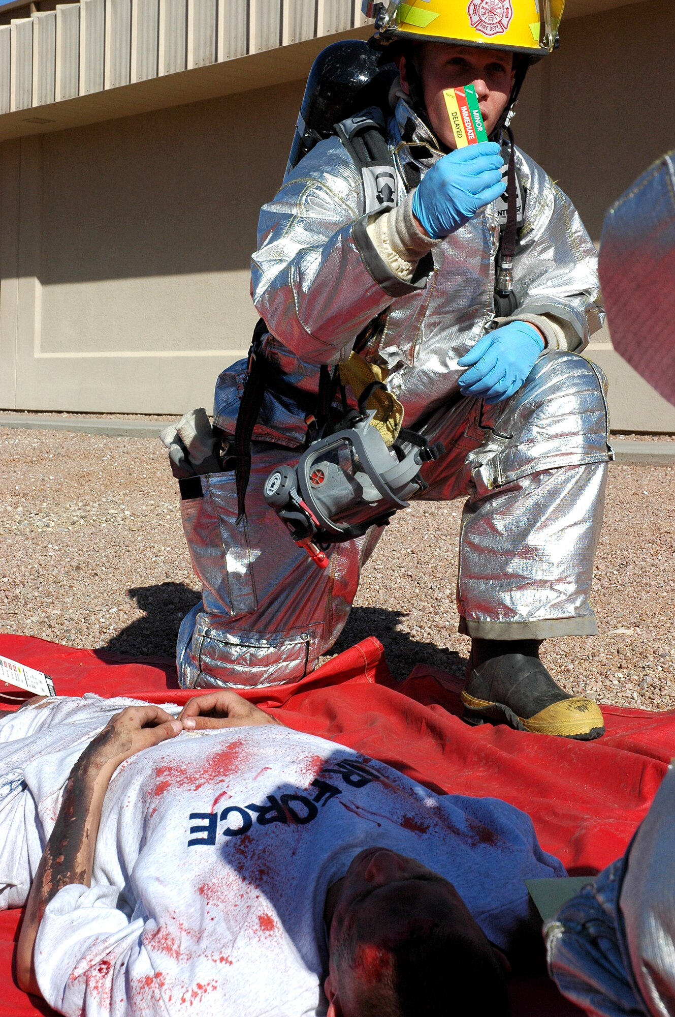 DAVIS-MONTHAN AIR FORCE BASE, Ariz. (AFPN) -- Senior Airman Brady White helps a "wounded" Airman Joseph Barrera during an accident response exercise here. Airman White is with the 355th Civil Engineer Squadron and Airman Barrera is with the 355th Mission Support Squadron. (U. S. Air Force photo by Airman 1st Class Clark Staehle)