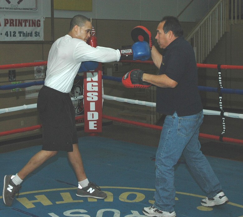 RAPID CITY, S.D. (AFPN) -- Airman 1st Class Andre Penn works the "mitts" with Eddie Martinez, Rapid City Boxing Club head trainer. Airman Penn is with the 28th Services Squadron. (U.S. Air Force photo by Senior Airman Joshua G. Moshier)