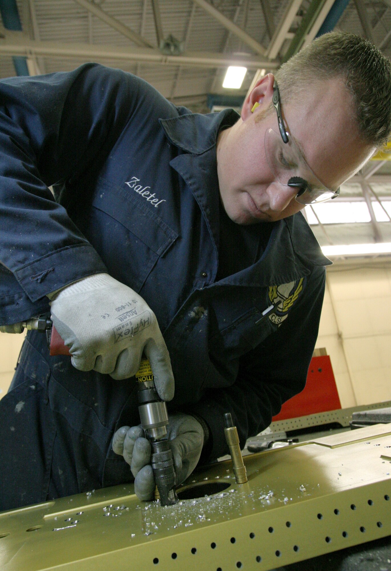 HILL AIR FORCE BASE, Utah (AFPN) -- Staff Sgt. Albert Zaletel, a depot aircraft structural maintenance craftsman, prepares the closure beam -- where a wing attaches to an F-16 Fighting Falcon's fuselage -- for fuel spool manifold installation. (U.S. Air Force photo by G.A. Volb)