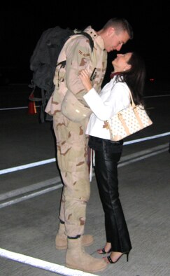 MOODY AIR FORCE BASE, Ga. - Airman 1st Class Jason Smith, 41st Helicopter Maintenance Unit, is greeted by Amy Pierce shortly after home from Balad Air Base, Iraq, Saturday. Approximately 25 Airmen from the 41st HMU and 41st Rescue Squadron arrived via a C-5 Galaxy after more than two months at Balad. (U.S. Air Force Photo by Senior Airman Shannon Fielder)