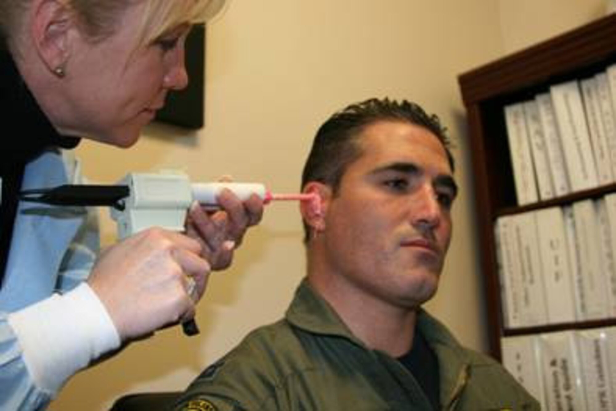 Master Sgt. Crystal Martin, 75th Aerospace Medicine Squadron, makes a mold of Capt. Dax Cornelius' inner ear. The mold will be used to make a new earplug system for the 4th Fighter Squadron Demo Team member.  (Air Force photo by Shad West)
