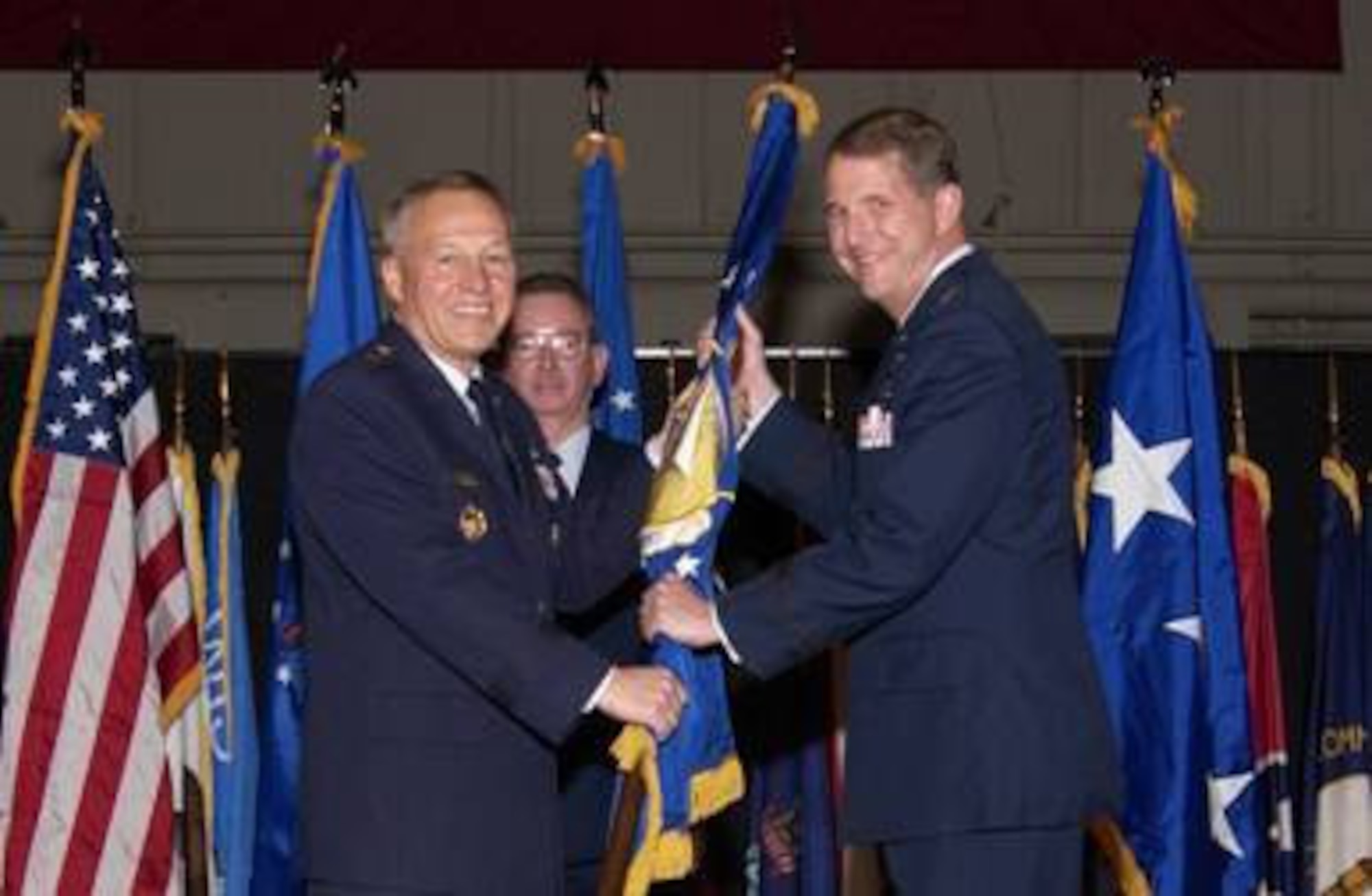Gen. Bruce Carlson, commander, Air Force Materiel Command, passes the flag to Maj. Gen. Ted Bowlds, during the Air Force Research Laboratory Appointment of Command ceremony Jan. 9 at the National Museum of the U.S. Air Force, Dayton, Ohio.    (Air Force photo by Marvin Baumgarter)

