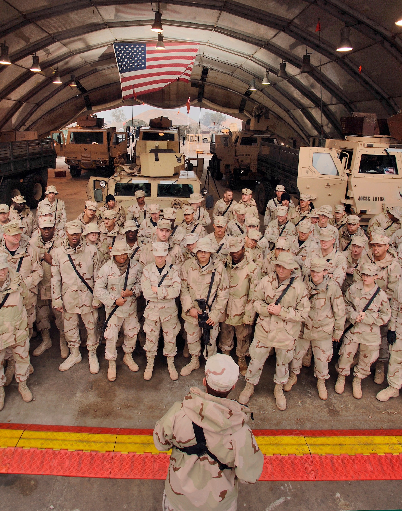 BALAD AIR BASE, Iraq (AFPN) -- Airmen with the 723rd Expeditionary Logistics Readiness Squadron gather after achieving the 4-million mile mark. The Airmen talked about their accomplishment and remembered Staff Sgt. Dustin Peters and Airman 1st Class Carl Anderson. The Airmen were gunners with the unit who were killed in action. The detachment ran its first convoy two years ago. (U.S. Air Force photo by Master Sgt. Lance Cheung)