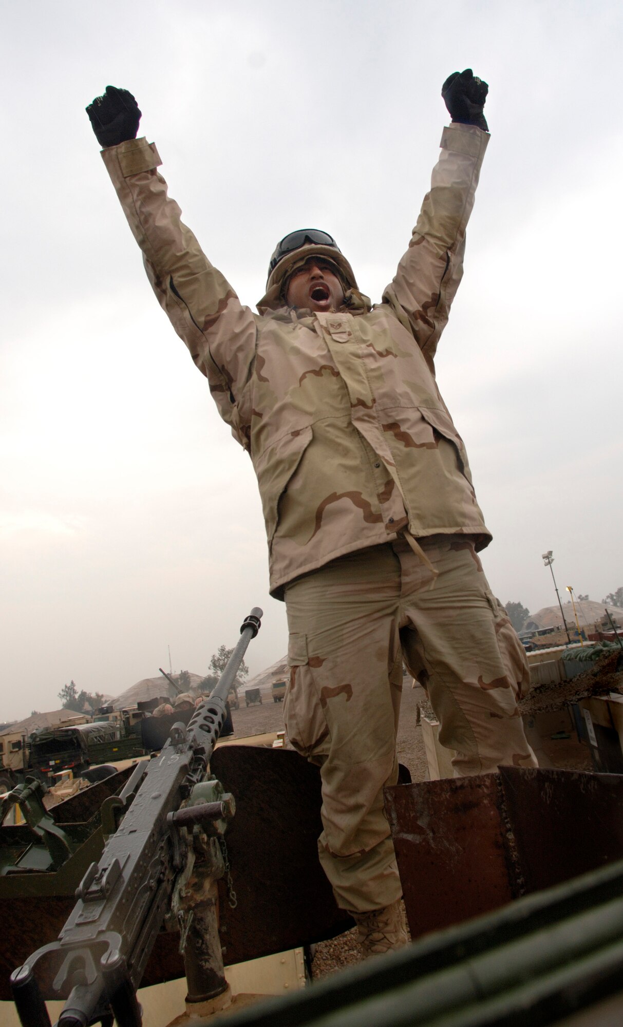 BALAD AIR BASE, Iraq (AFPN) -- Staff Sgt. Viktor Hancock celebrates the completion of a convoy security mission that achieved the unit's 4-million mile mark. As a gunner he operates the roof-mounted 128-pound, 50-caliber M2 machine gun. When called upon he can unleash 450 to 550 rounds per minute at up to 6,764 meters away. Sergeant Hancock is assigned to the 732nd Expeditionary Logistics Readiness Squadron and is deployed from Nellis Air Force Base, Nev. (U.S. Air Force photo by Master Sgt. Lance Cheung)