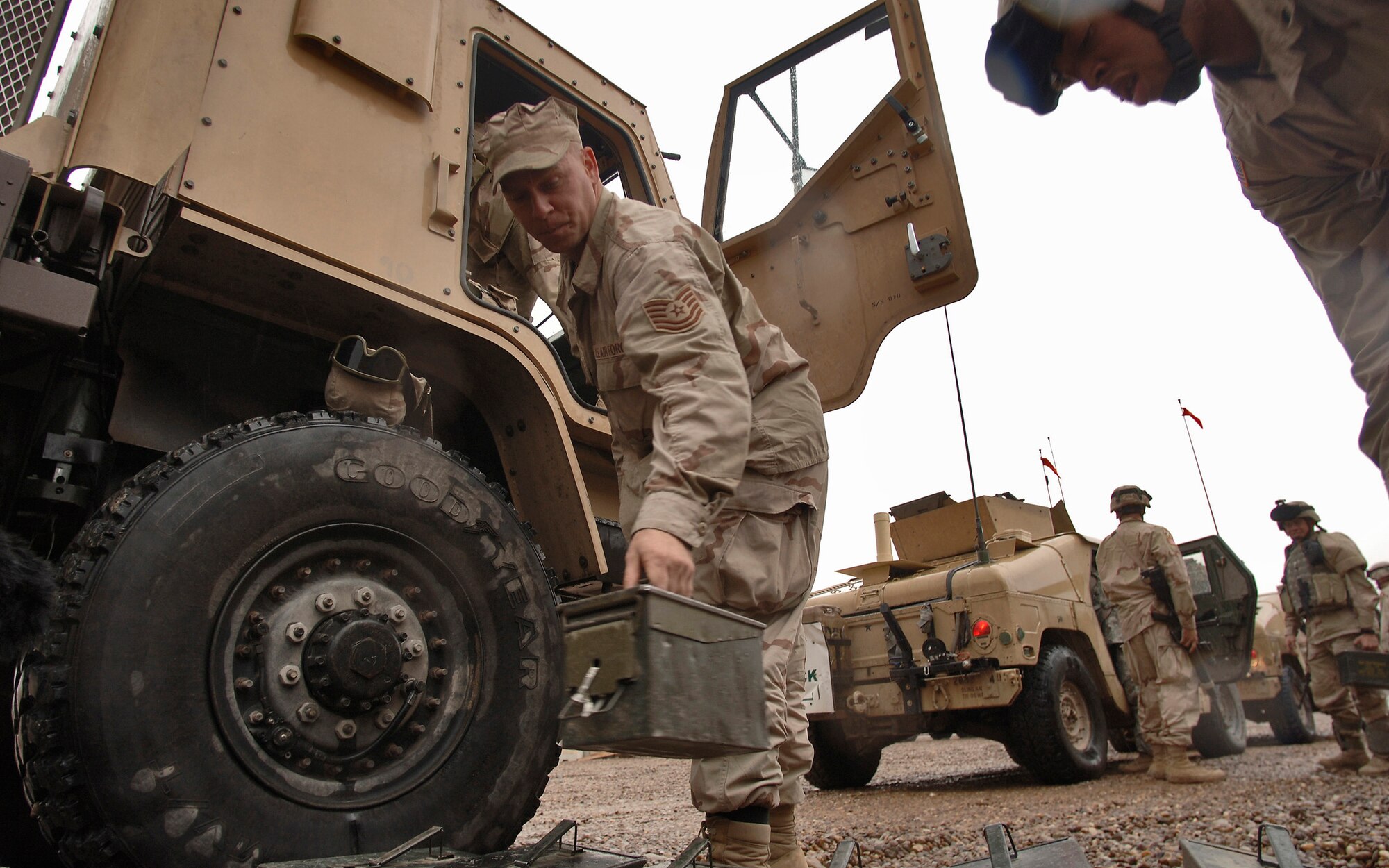 BALAD AIR BASE, Iraq (AFPN) -- Tech. Sgt. David Freid unloads boxes containing hundreds of 50-caliber ammunition rounds from an armor-modified vehicle. He and a team of Airmen and Soldiers completed a convoy security mission that achieved the unit's 4-million mile mark Jan. 7. Sergeant Freid is a truck commander with the 732nd Expeditionary Logistics Readiness Squadron and is deployed from Langley Air Force Base, Va. (U.S. Air Force photo by Master Sgt. Lance Cheung) 